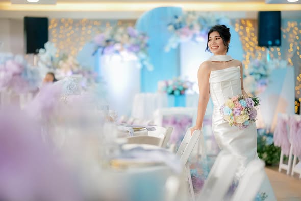 Bride smiling inside a softly lit reception