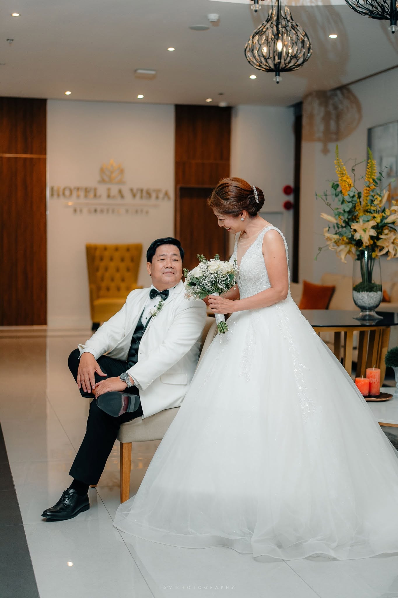 Bride and groom sharing a relaxed moment before their celebration