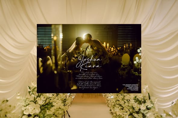 Elegant wedding reception stage framed by flowers and soft draping